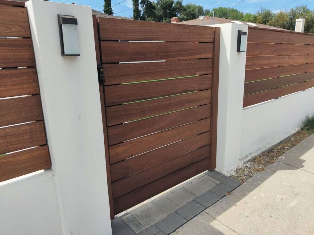 Horizontal Mahogany Wood Gate between columns. 